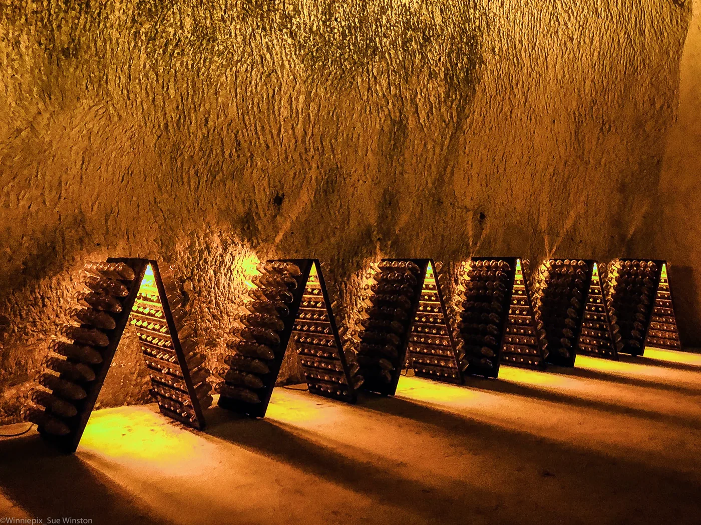 Bottles ageing in a chalk Champagne cellar